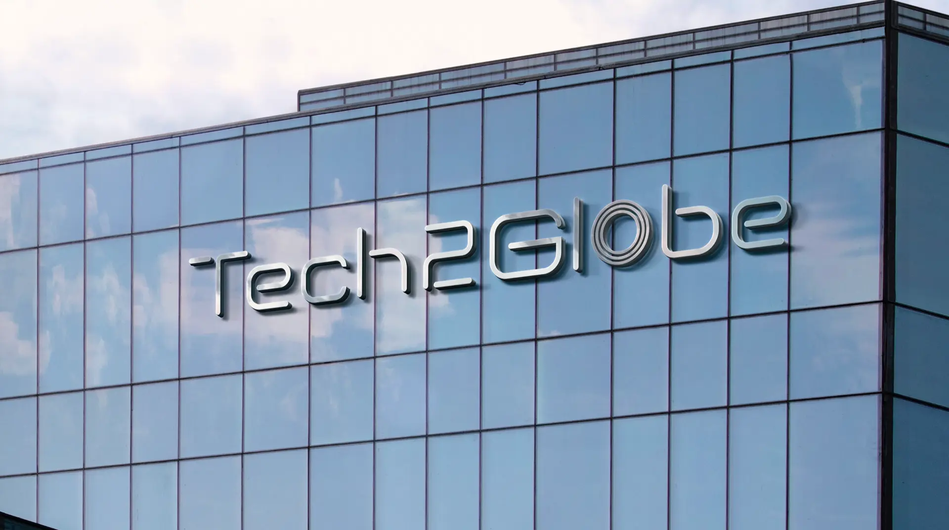 Tech2Globe dimensional wordmark signage on a glass office building